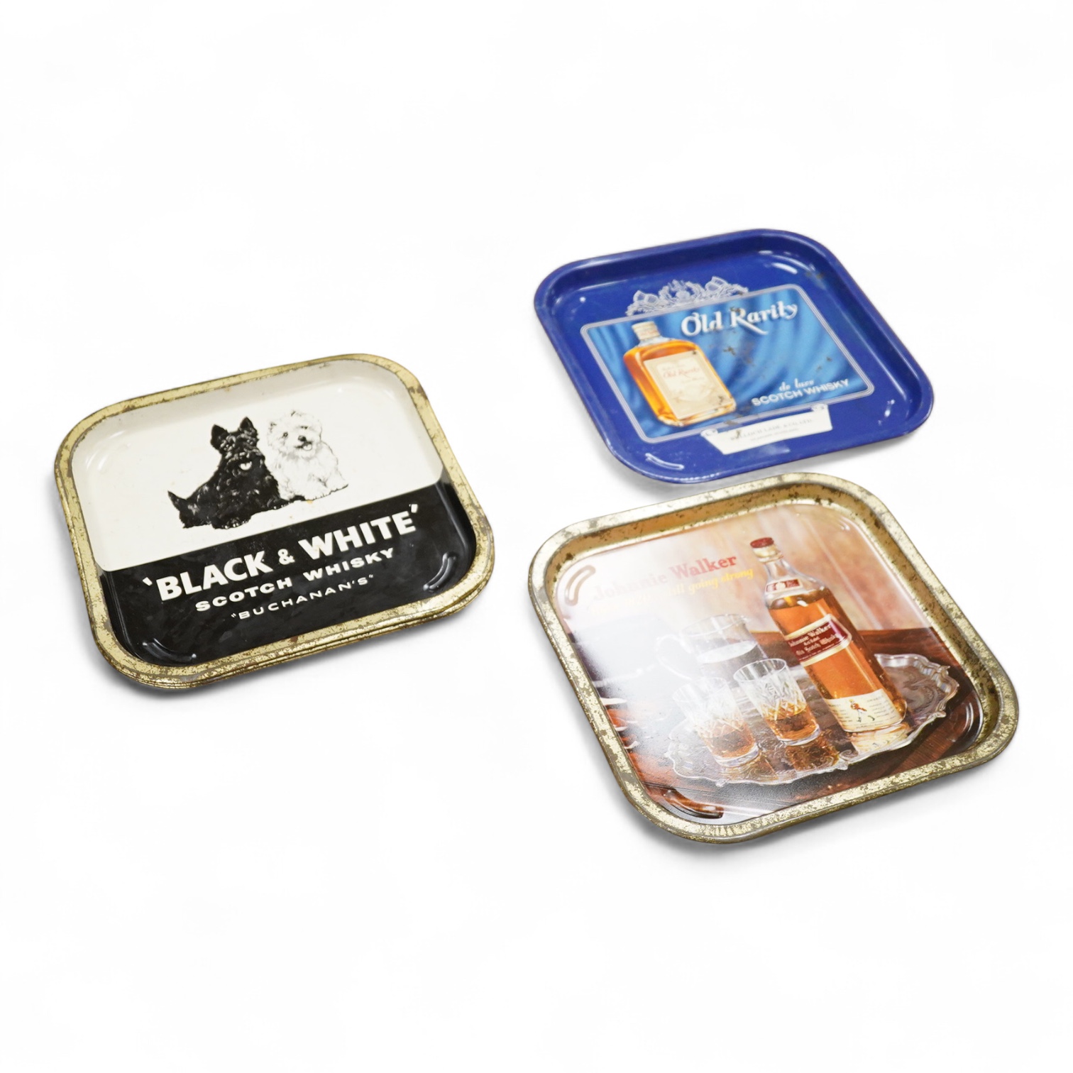 Five 1960s pub advertising trays for Scotch Whisky to include Johnnie Walker and Black & White, Buchanans, 35cm wide